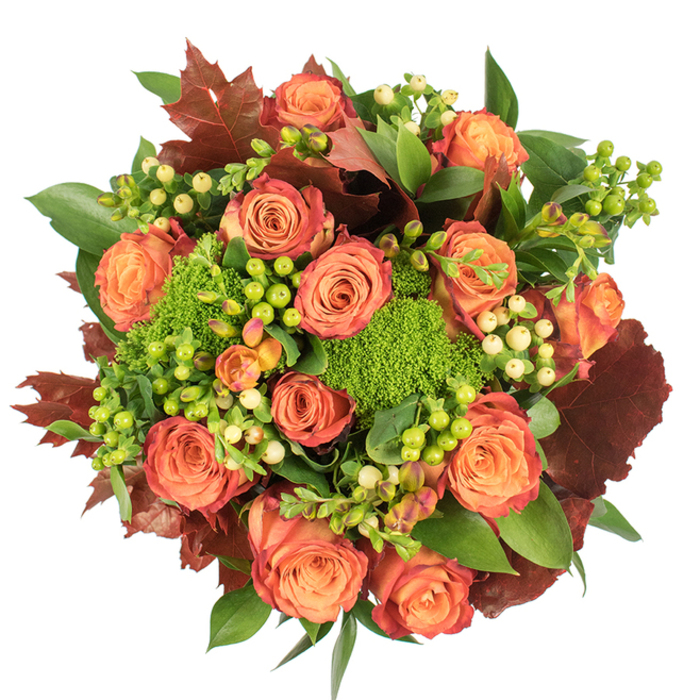 Viewed from above on a crisp white surface, this autumnal bouquet reads like a small harvest gathered from the neighbourhood-an expression of warmth that would feel at home on any Tooting table. The arrangement is densely composed and circular, dominated by a profusion of fully opened roses in hues that range from soft peach through coral to a deeper, glowing orange; the outer petals carry a faint russet wash, creating a natural gradient that mirrors the turning leaves at Tooting Common. Nestled among the roses are clusters of Hypericum berries-vivid lime-green alongside pale cream and buttery-yellow berries-offering tiny glossy accents that lend rhythm and playfulness. Textural contrast comes from mounded Green Trick dianthus, their velvety, moss-like forms introducing a lively, tactile surprise that grounds the composition. Interspersed are large, lobed leaves in rich burgundy and brown tones, suggestive of maple or oak foliage, which give the bouquet a seasonal, almost rustic character. Fresh green foliage-some broad and reflective, some matte and serrated-fills and frames the blooms, creating depth and a feeling of abundance. Soft, diffuse lighting reveals petal velour and berry sheen while producing gentle shadows that model each form. The scent is quietly floral with an earthy undernote, an evocative reminder of damp paths and market stalls on a brisk Tooting morning. Crafted with the eye of a neighbourhood florist, this piece makes a sophisticated Thanksgiving centrepiece, a comforting gift, or an autumnal accent for a cosy home.